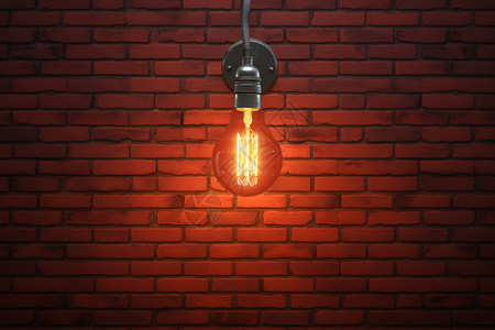 悬挂在红砖墙上的灯泡图片