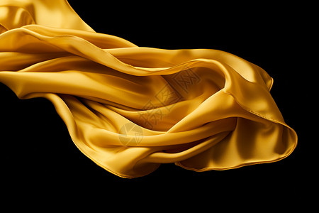 金黄色的丝带飘动在黑色背景下图片