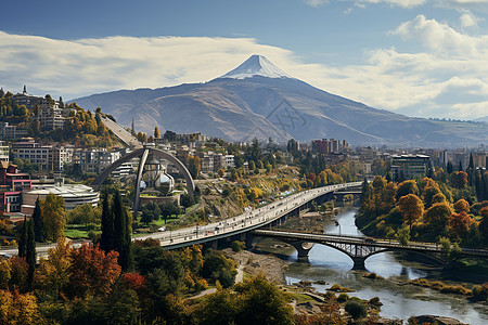 桥横跨山脉和城市背景图片