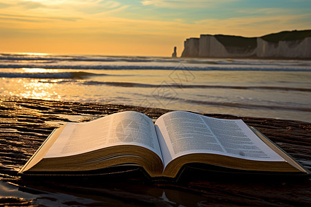 海滩上翻开的书籍背景图片