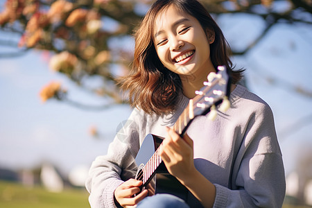 快乐的女孩拨弄吉他图片