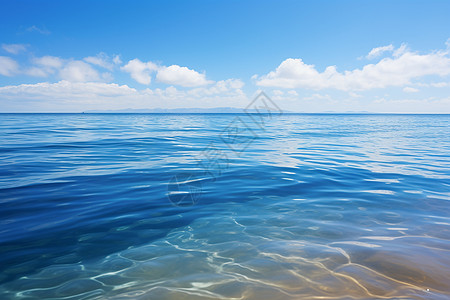 蓝天白云波光粼粼的海滩背景图片