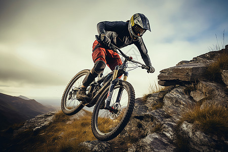 站在山崖上人骑着自行车在山岩上下坡的人背景