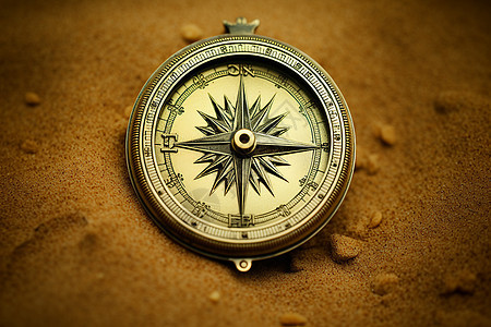 沙丘中的黄铜指南针背景图片