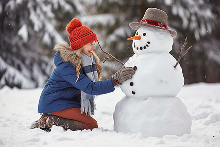 女孩在公园里堆雪人图片