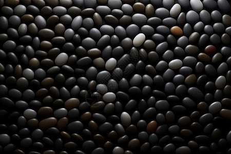 光滑的黑色鹅卵石背景图片