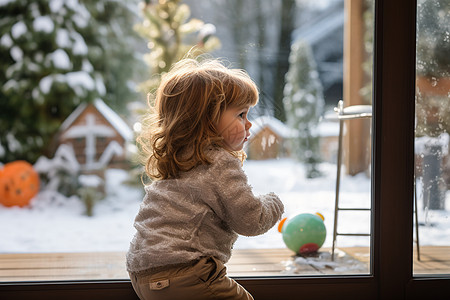 可爱小女孩窗前望雪图片