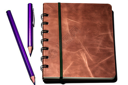 褐色皮革覆盖的棕色笔记本背景图片