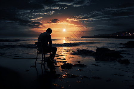 一个人坐在沙滩上图片