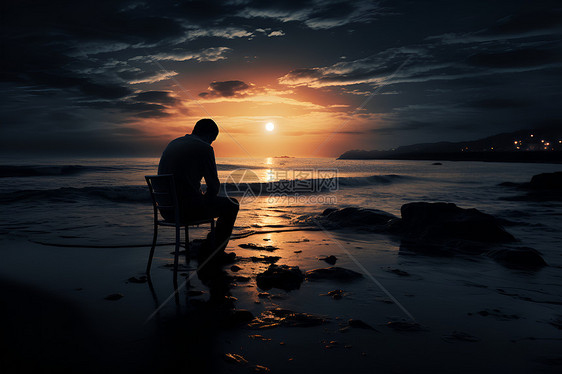 一个人坐在沙滩上图片
