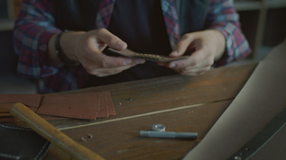 手工匠在家庭讲习班中制作皮革钥匙链视频素材