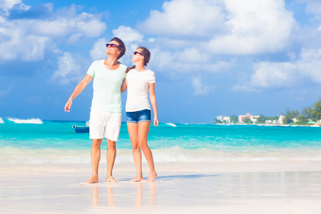 快乐的年轻夫妇，在海滩上的太阳镜