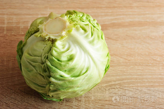 整个新鲜绿色卷心菜头部的木制背景照片-正版商用图片00