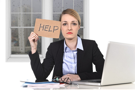 年轻强调女商人持有劳累在办公室计算机上的帮助标志