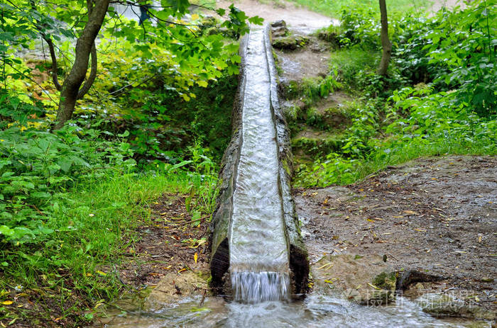 在公园里的木制天沟水流动的流