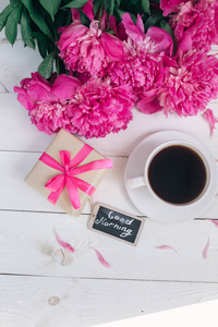 粉色牡丹鲜花 礼品盒 杯咖啡和笔记早上好从早餐上母亲节或妇女节白色仿古桌上