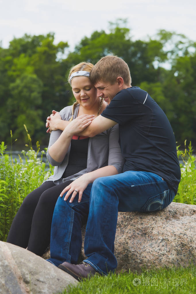 男人微笑着拥抱他的女朋友保持温暖