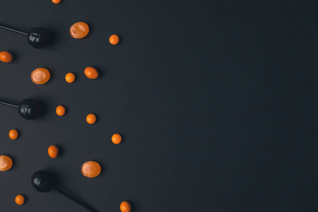 黑色和橙色的棒棒糖照片