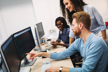 开发人员的后视图工作在编程代码的耳机中一个年轻的程序员看着相机