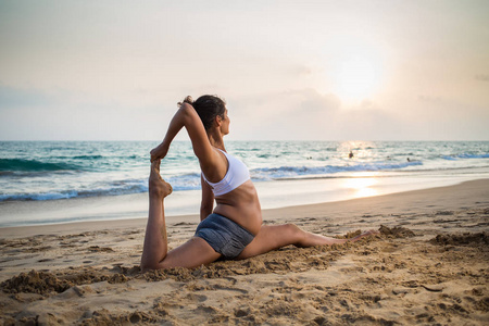 自然怀孕女人练瑜伽在海边