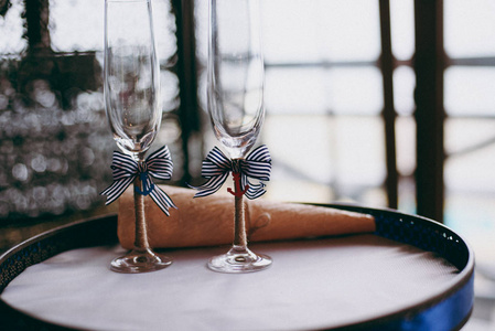 两杯香槟粉红玫瑰的婚礼花束的背景。软焦点，选择性焦点