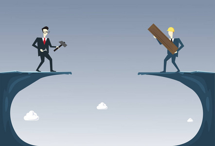 商务人士建筑桥梁在悬崖差距合作伙伴支持商人合作概念照片