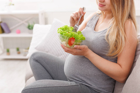 年轻孕妇吃的新鲜绿色沙拉