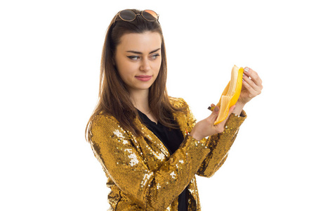 可爱时尚的女人，穿着金色夹克着香蕉