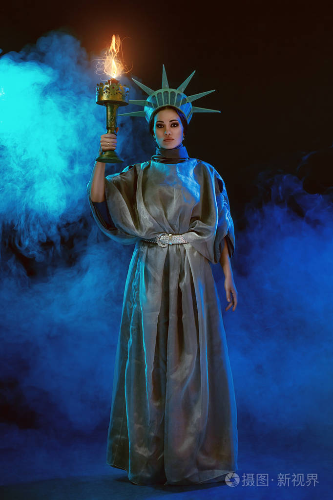 年轻女子在舞台服装的脱衣舞娘摆姿势