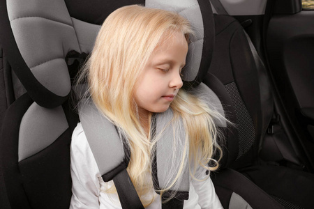 金发女孩睡在儿童安全座椅图片