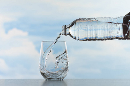 水溅在透明的玻璃后倒水照片