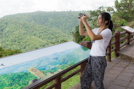 女人的徒步旅行者在山相机合影