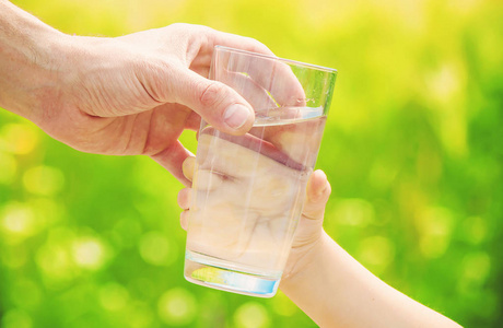 父亲给孩子一杯水.选择性的焦点照片