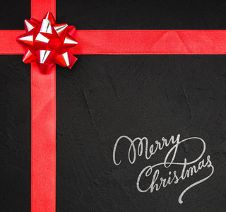 红丝带和装饰弓, 圣诞快乐标志黑色, 石头背景, 从上面, 上面, 圣诞贺卡与空间文本