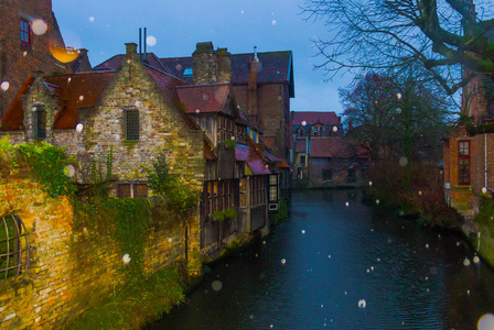 比利时布鲁日一条运河上的历史性中世纪建筑的晚间拍摄