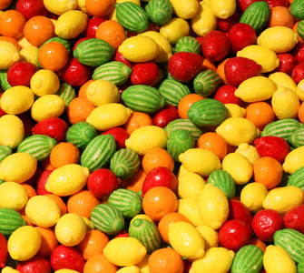 许多甜糖果的背景, 各种形式的柑橘 f
