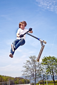 一个带着滑板车的男孩图片