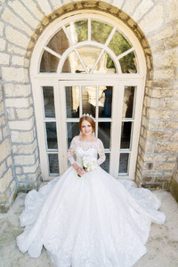 一个美丽的新娘在白色的礼服和花束在她的手的肖像