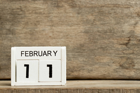 白色方块式日历当前日期11和月2月在木背景