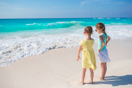热带海滩的小女孩一起在海边玩耍