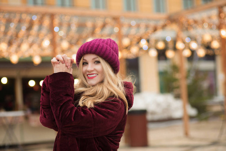 美丽的年轻女子身穿红色针织帽和冬季大衣, 宝