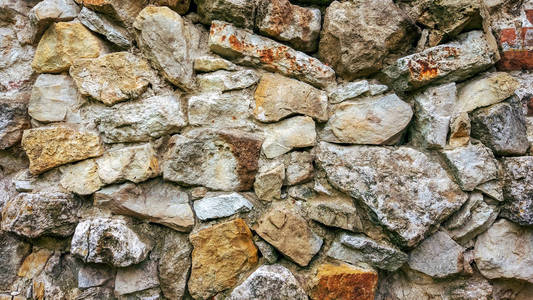 石老墙用大块。石头的背景。概念的可靠性。石头之间的空间充满了水泥