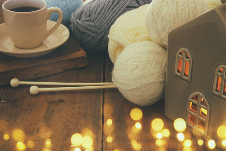 羊毛和杯热咖啡木制的桌子上的温暖和舒适的毛线球
