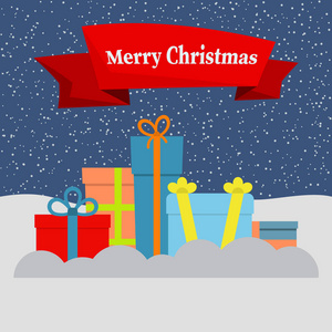雪和飘落的雪的礼物盒和一个红色的丝带与题词快乐的圣诞节