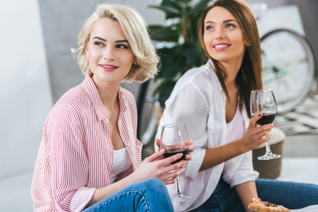 迷人的微笑的妇女与红葡萄酒共度时光