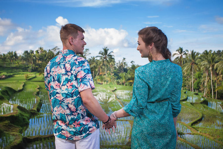 幸福的情侣走在梯田。在巴厘岛旅游