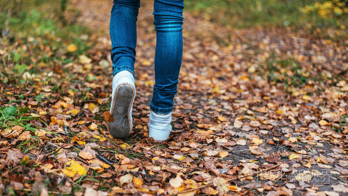 一个男人停止行走.女孩的女朋友.在公园里的黄色树叶间性质的辣妹.