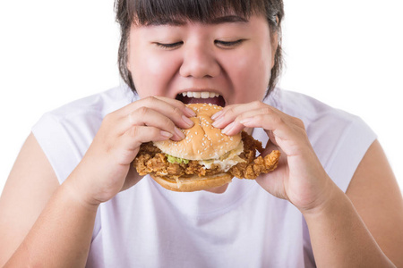 肥胖亚洲妇女吃炸鸡汉堡在白色被隔绝