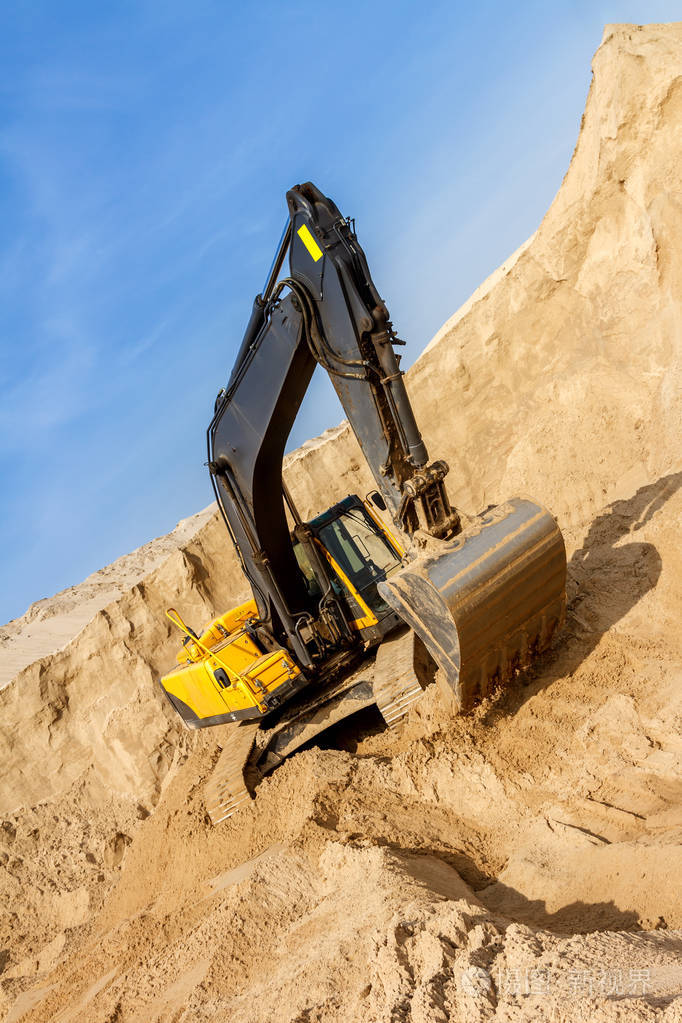 黄色挖掘机在建筑工地工作在晴天