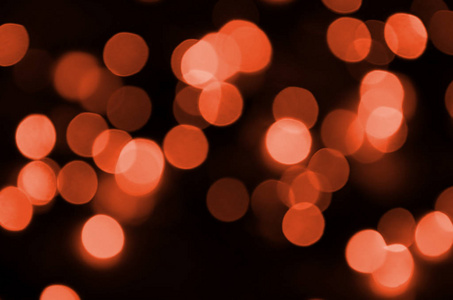 抽象模糊的红色闪闪发光的灯泡背景灯。模糊圣诞节壁纸装饰概念